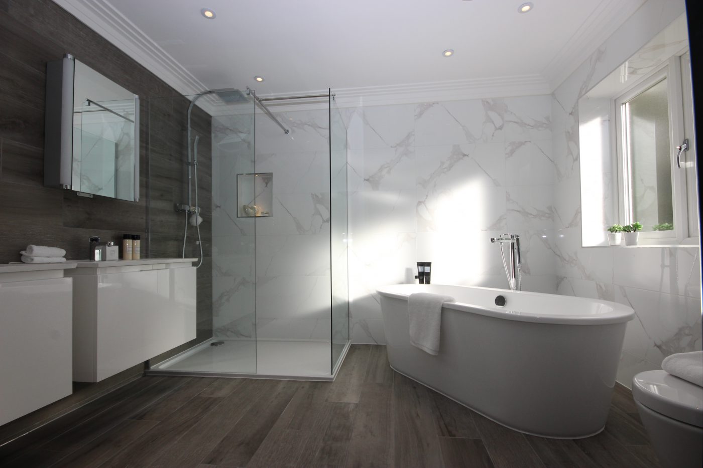 Marble-tiled bathroom with freestanding bath